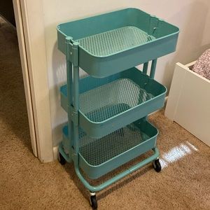 A teal- ish colored storage unit from ikea that will complete your house!